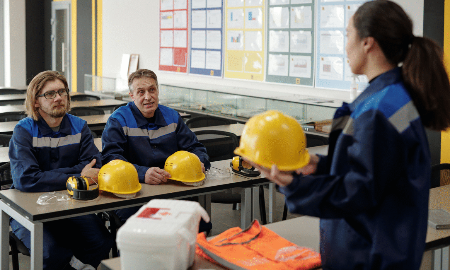 Safety Training Instructor holding a hardhat during training with students